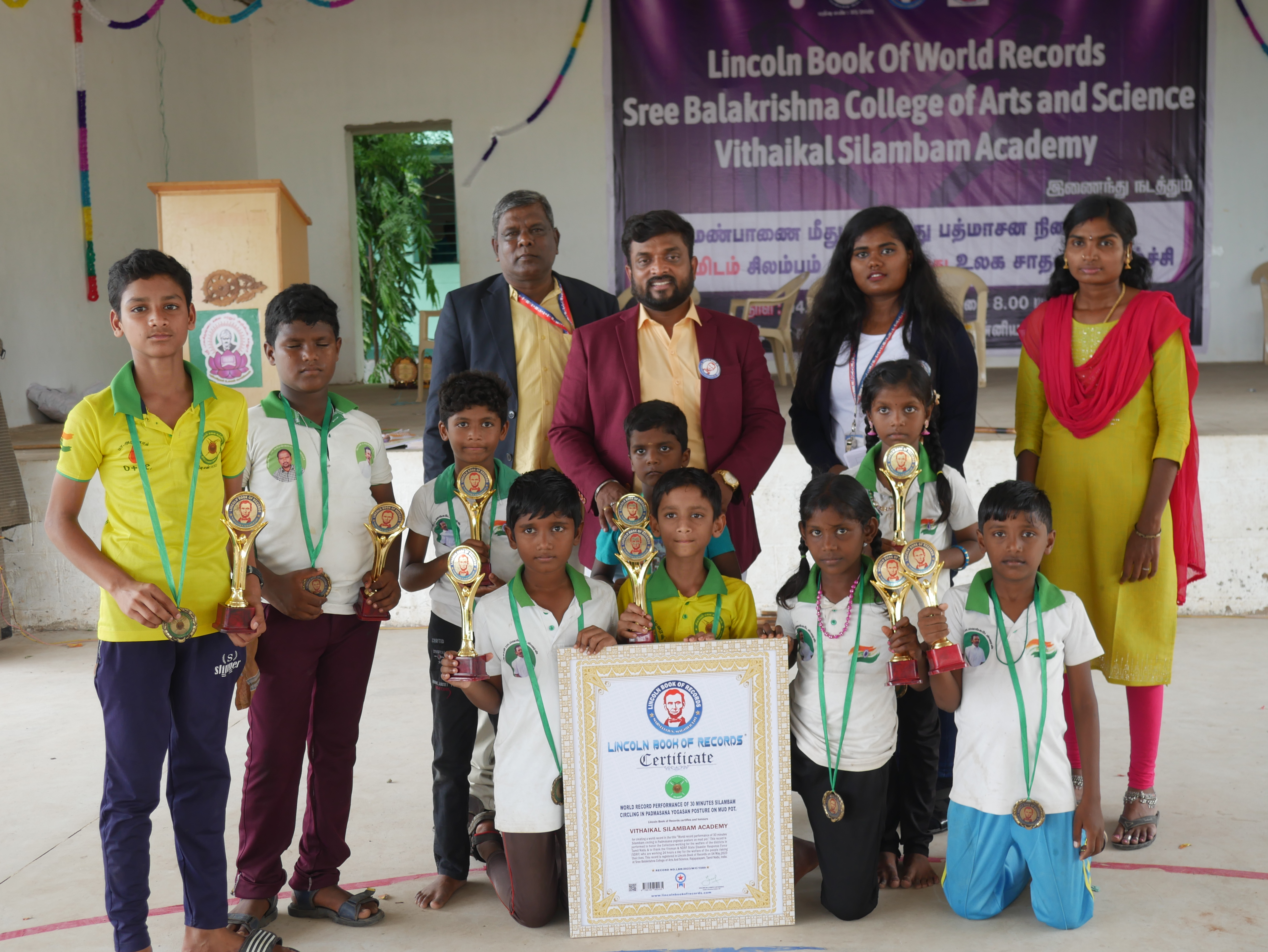 World record performance of 30 minutes Silambam  circling in Padmasana yogasan posture on mud pot.