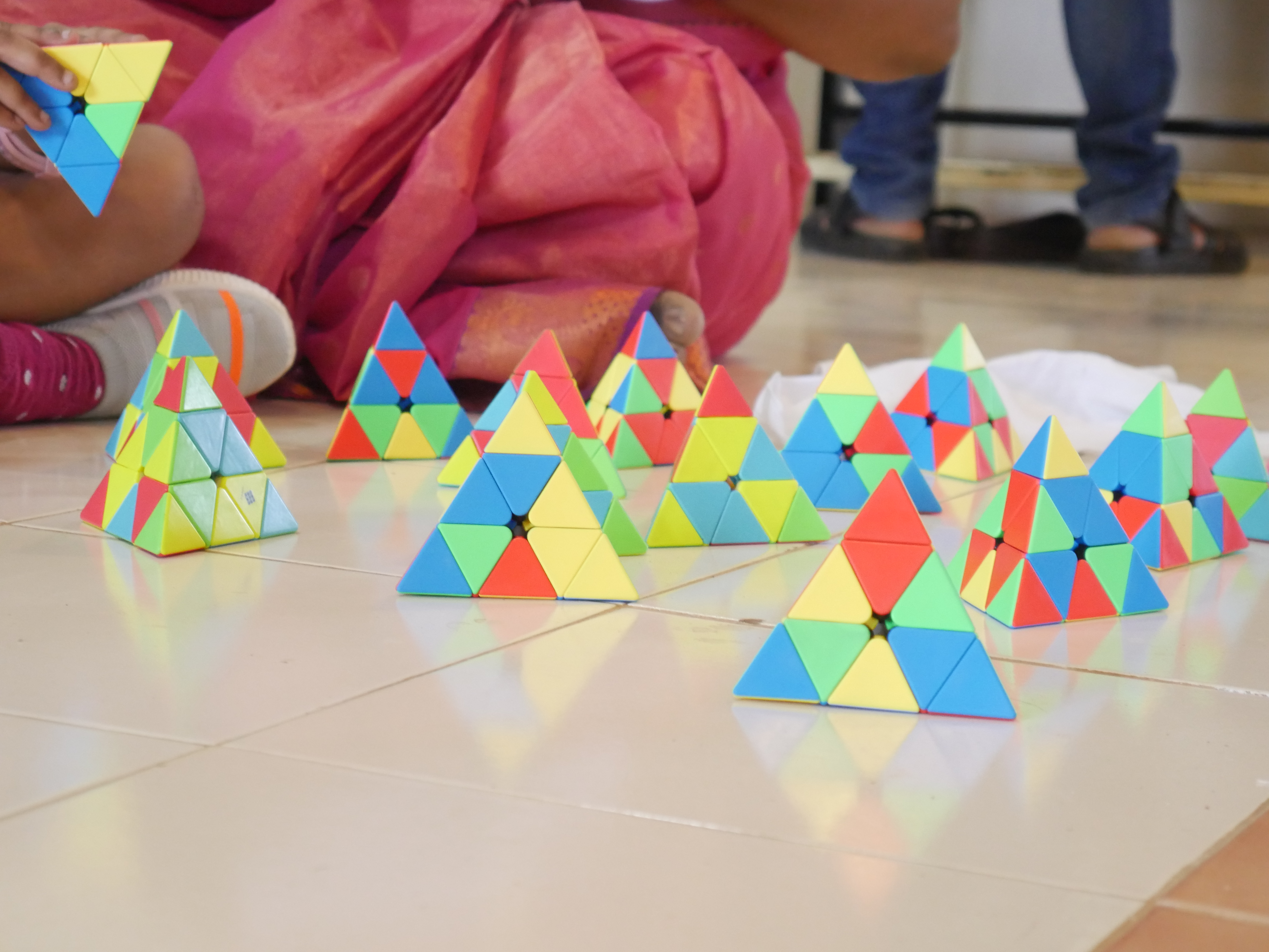 World's youngest child to solve larger number of Pyramid Rubik's Cube  by reciting multiple Tamil articles  simultaneously in 06 minutes.